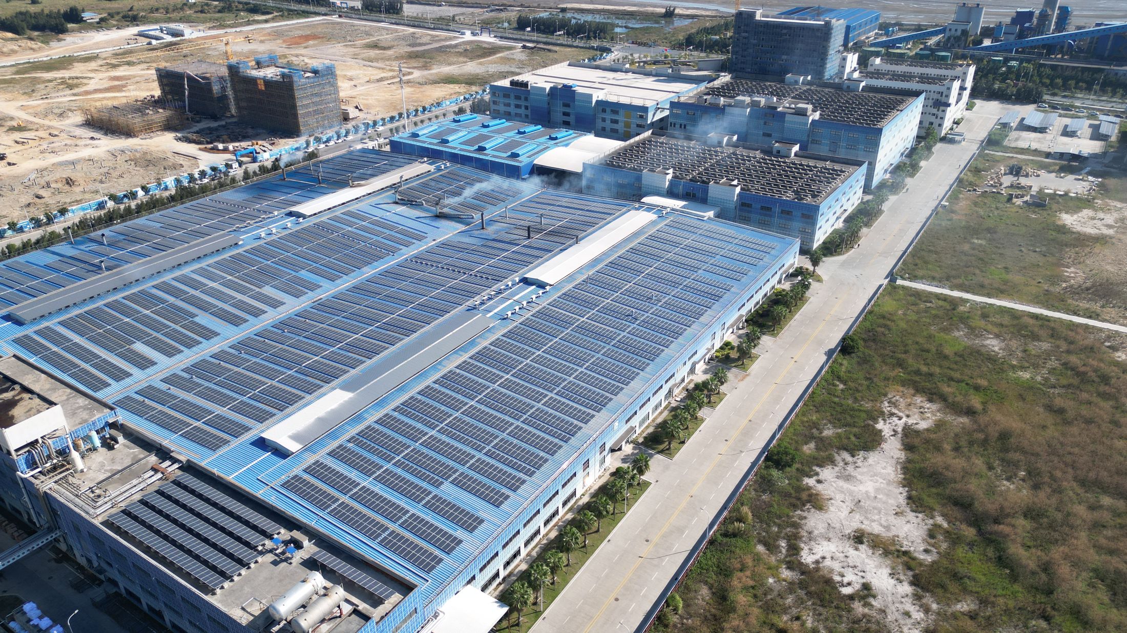 An industrial facility with extensive rooftop solar panels