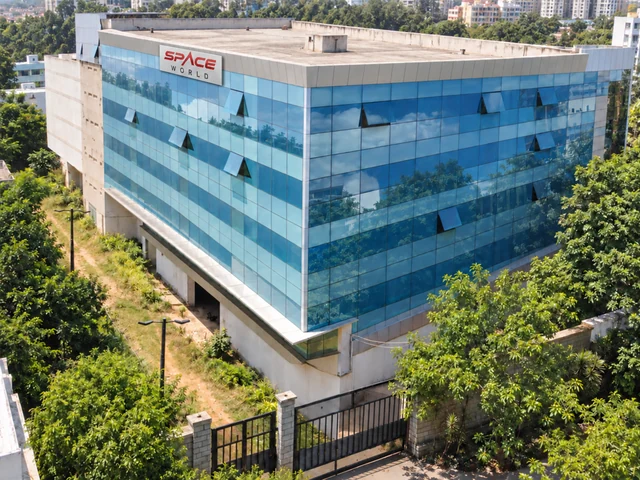 Elevated exterior view of the Space World building with its blue-glass facade and signage